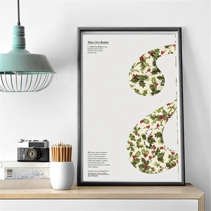 Detail of vintage Christmas poster with holly alphabet design in a black minimalist frame