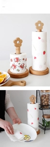 Detailed view of beech wood kitchen towel holders with decorative flower top and stable base