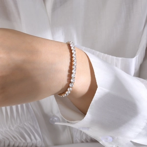 Classic gold-plated tennis bracelet with sparkling zircon stones worn on wrist