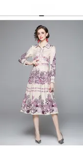 Detail of high-waisted midi dress featuring purple floral print and button-down collar