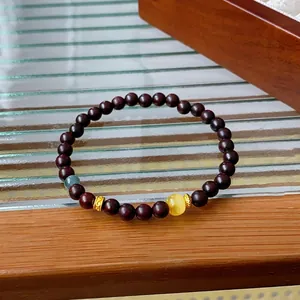 Vintage style sandalwood beaded bracelet with blue gemstone and yellow amber bead accents