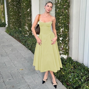 Elegant pale green backless midi sundress with cinched waist and flowing skirt