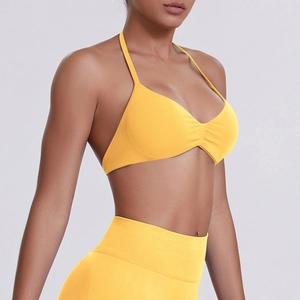 Detail of seamless yellow halter sports bra with ribbed texture and high elasticity