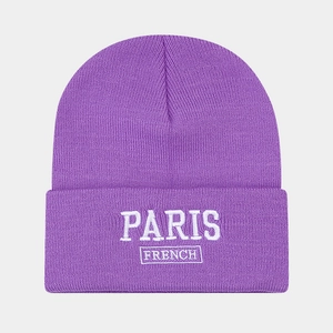 Detail view of purple knit beanie with white PARIS FRENCH embroidery on the cuffed brim