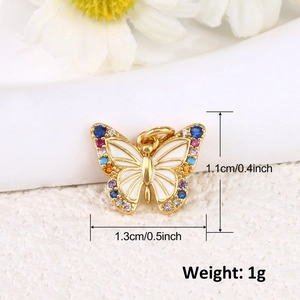 Macro detail of gold butterfly pendant with colorful zircons and size measurements