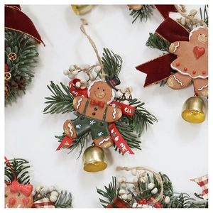 Detailed Christmas gingerbread man ornament with red bow, pine needles and gold bell