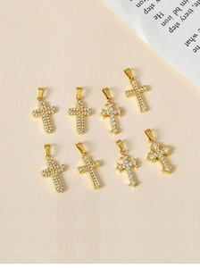 Detailed close-up of gold cross pendants with micro-paved zircons in eight various styles