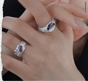 Detailed shot of irregular texture S925 silver rings with purple gemstone inlay