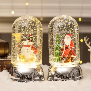 Christmas musical snow globe set featuring Santa and Snowman with warm festive lighting