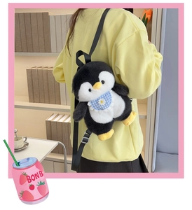 Detail of cute penguin plush backpack worn by a girl against an indoor bookshelf