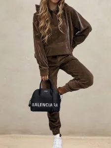 Detail of premium brown velvet tracksuit with hoodie and matching joggers for a luxury look