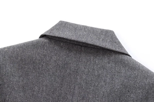 Close-up of classic grey herringbone wool blend fabric on lapel and shoulder seams