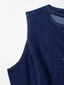 Detail of dark blue denim fabric with reinforced contrast yellow stitching and twill texture