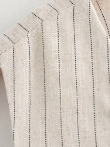 Close-up of oatmeal striped linen vest showing shoulder seams and fabric texture