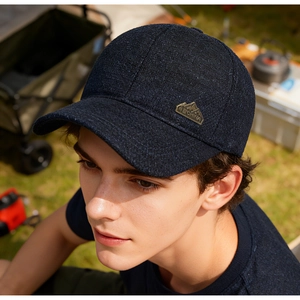 Detail of navy winter baseball cap featuring fleece lining and mountain metal logo