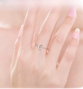 Dettaglio macro di un anello a catena in argento S925 con motivo a luna micro-pavé