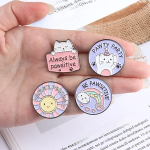 Set of four cute cat enamel pins with positive quotes on a minimalist round badge