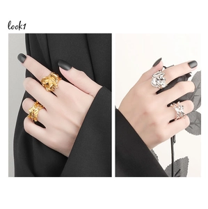 Close-up of gold and silver rings with irregular liquid metal lava texture on model hands