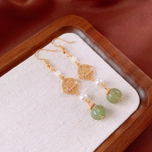 Detailed view of Chinese style floral earrings with green pumpkin beads and pearls