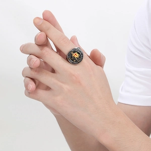 Detailed close-up of vintage steel ring with red cross shield and engraved bible verses