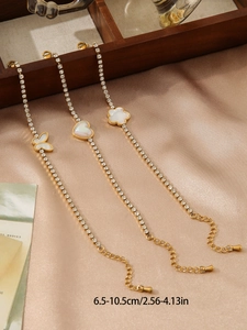 Detailed view of gold flower heart butterfly bracelets with length specs on silk