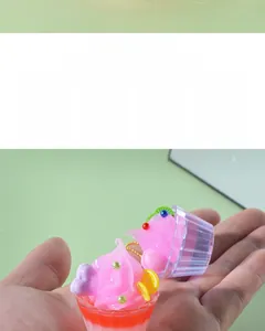 Detailed close-up of a mini pink sundae charm with faux fruit slices and metal chain