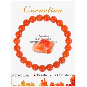 Macro detail of round carnelian bead bracelet with informative stone property card