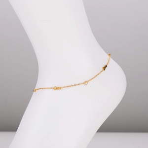 Elegant gold LOVE anklet with sparkling diamonds shown on a model foot model
