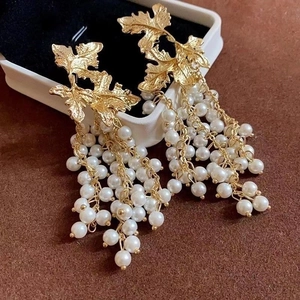 Vintage gold leaf cluster earrings with white pearl tassels and luxury drop design