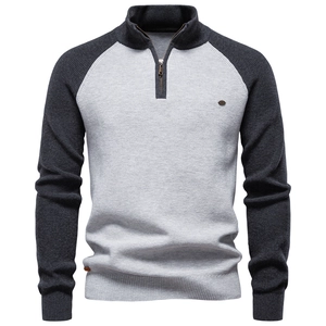 Detailed view of men's half-zip knit sweater with contrast raglan sleeves and ribbed cuffs