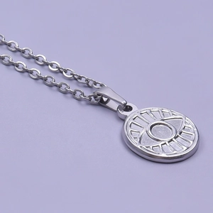 Macro view of silver evil eye pendant necklace with embossed stainless steel details