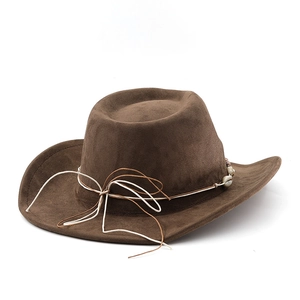 Detail of dark brown suede cowboy hat featuring woven rope and seashell decorative band