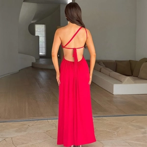 Detail of red backless halter dress showing elegant lace-up straps and flowing silk fabric