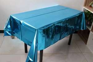 Detail of disposable blue metallic foil tablecloth with shiny reflective surface