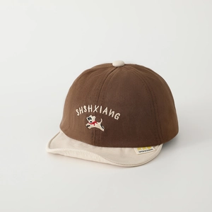Detailed close-up of brown canvas baby cap with cute puppy embroidery and soft brim