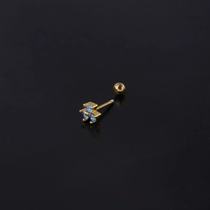 Detail of clover-shaped gold stud earring with three light blue cubic zirconia stones