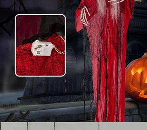 Detail of red Halloween witch ghost with battery compartment and skeleton hands