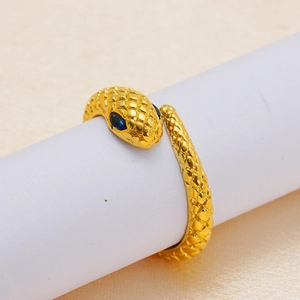 Detailed macro view of golden snake ring with blue gemstone eyes and scale texture