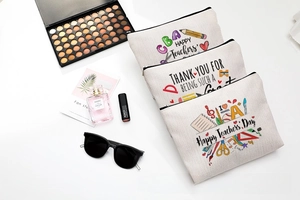 Three cotton linen teacher gift cosmetic bags with floral patterns on white surface