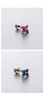 Detailed view of flower-shaped titanium steel ear studs in rose red and deep blue