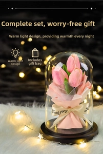 Detail of pink tulip artificial flower night light in glass dome with warm LED glow