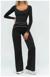 Détail de l'ensemble de yoga noir avec liseré contrasté blanc et pantalon évasé
