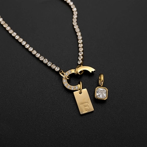 Gold plated titanium steel necklace with pavé horseshoe clasp and engraved letter F charm
