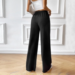 Women's black high waist wide leg pants with elastic waist shown from back view