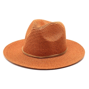 Detail of woven straw fedora hat featuring a fine leather band and orange sun protection brim
