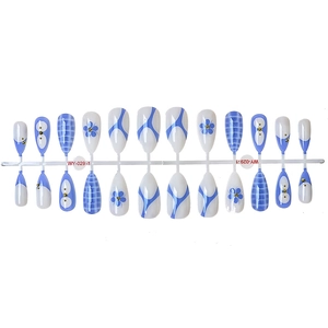 Blue and white floral press-on nails with almond shape and geometric patterns