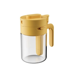 Two-in-one glass seasoning jar with yellow lid and spoon for kitchen storage