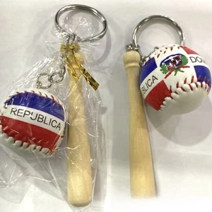 Detail of Dominican Republic baseball keychain with a mini wooden bat and leather ball