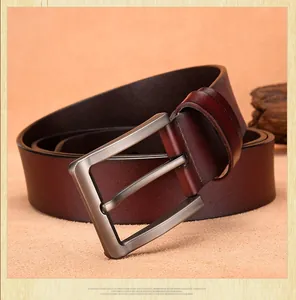 Macro shot of dark brown genuine leather belt with matte brushed metal pin buckle