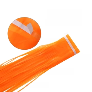 Detail of orange PET tinsel curtain featuring self-adhesive tape for party backdrops